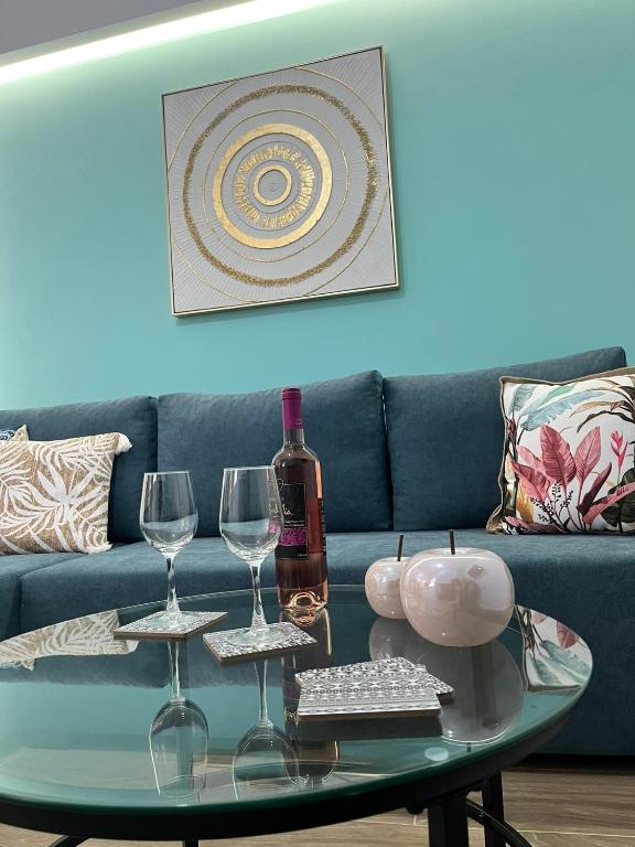 a table with two glasses and a bottle of wine at Charavgi House in Archangelos