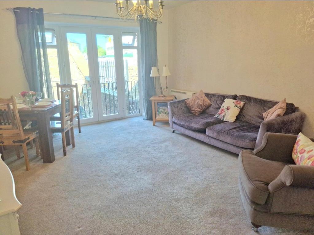 a living room with a couch and a table at Fenkle Street Alnwick Apartment in Alnwick