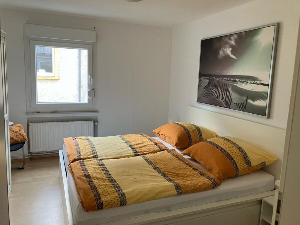 a bedroom with a bed and a picture on the wall at Apartment in Osnabrück in Osnabrück
