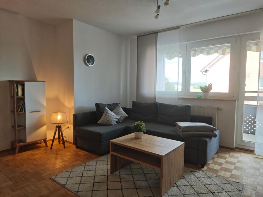 a living room with a couch and a coffee table at Ferienwohnung mit Kanalblick in Hirschaid