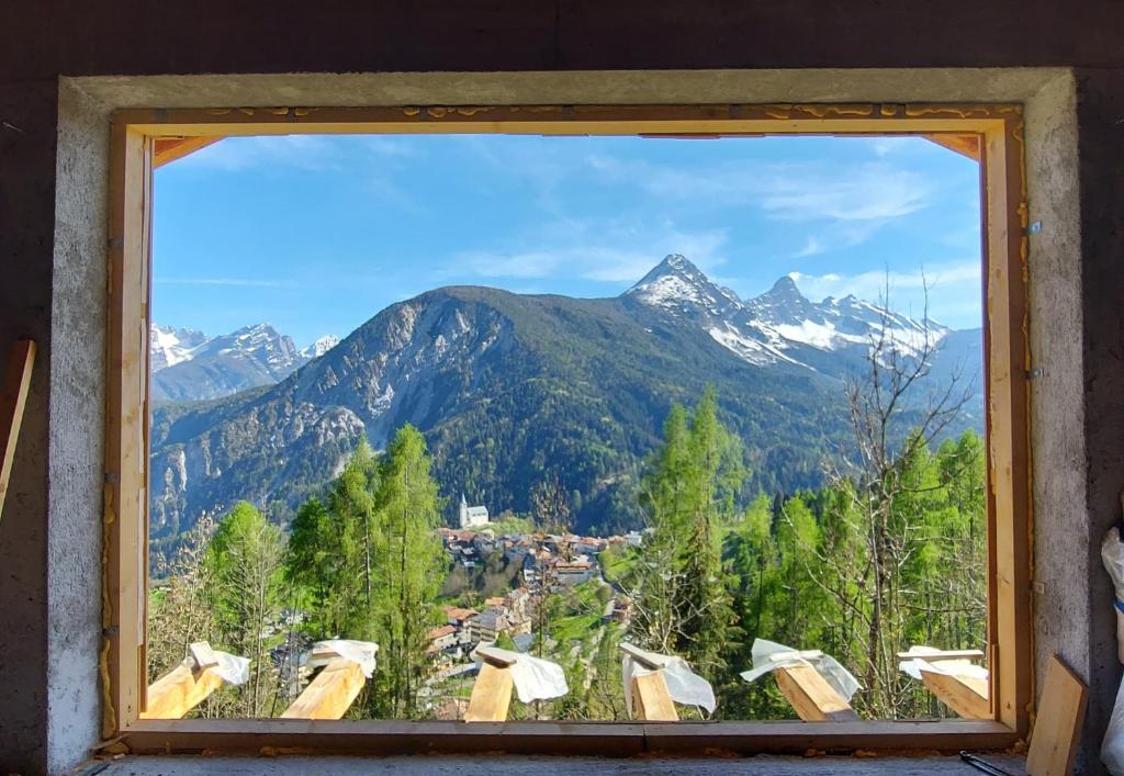 a window with a view of a mountain at BATAJA - Dolomites Lodge in Valle di Cadore