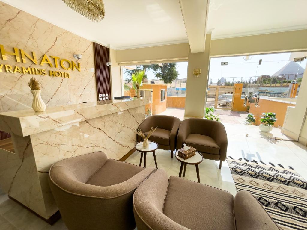 a lobby with couches and chairs in a building at AKHNATON Pyramids View Hotel With Rooftop Access & free airport pickup in Cairo