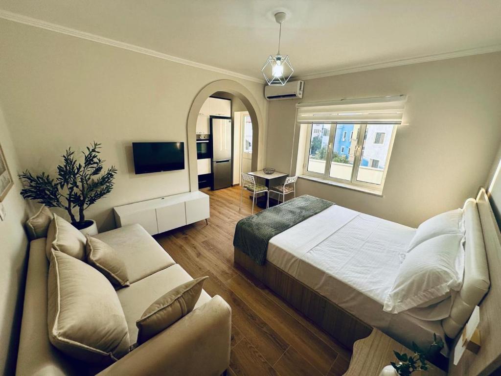 a bedroom with a large bed and a couch at Holiday Home Lezha 2 in Lezhë
