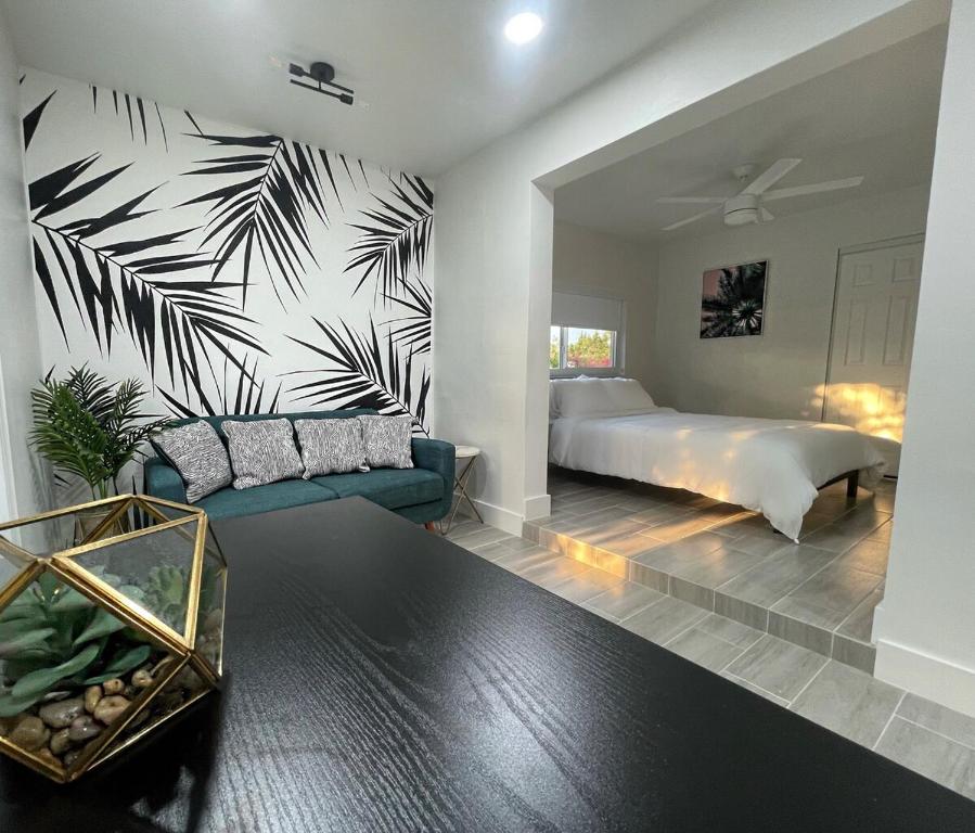 a bedroom with a bed and a couch in a room at The Vice City Suite - Private stay with Free Parking in the Heart of Miami in Miami