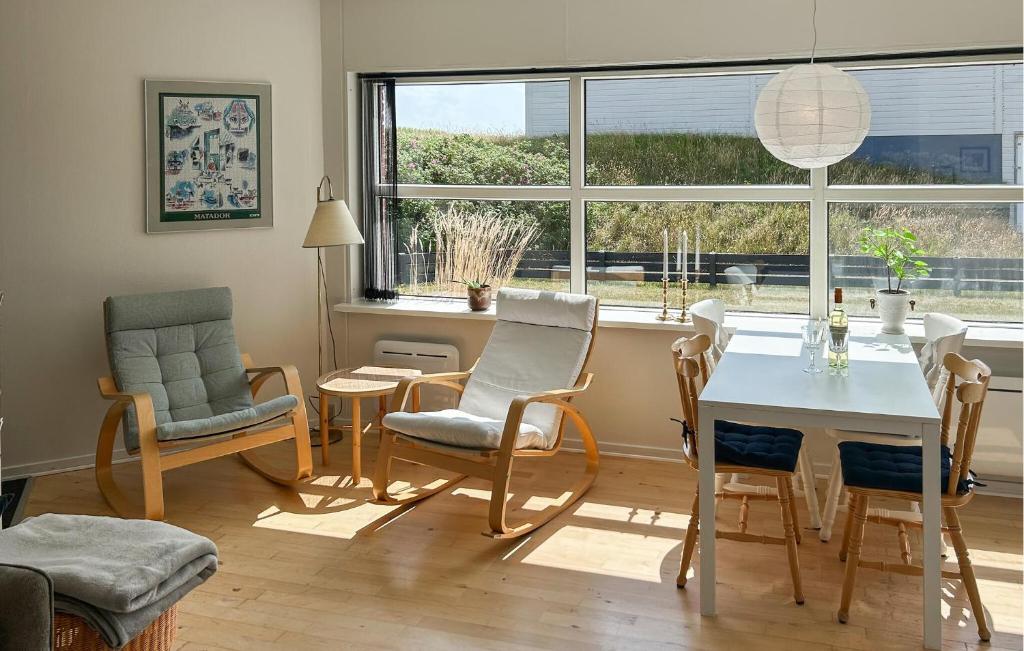 a living room with a table and chairs and a window at 2 Bedroom Stunning Apartment In Fanø in Fanø