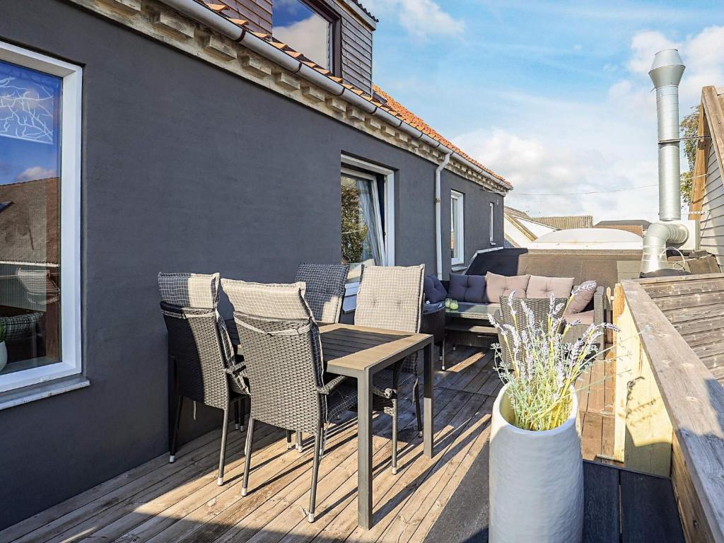 a patio with chairs and a table on a deck at 5 person holiday home in Snedsted in Snedsted