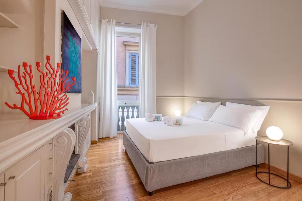 a bedroom with a white bed and an aquarium in it at Navona Boutique House in Rome