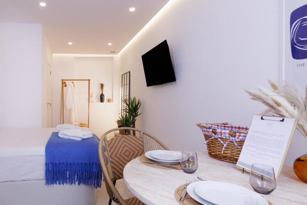 a dining room with a table with plates on it at Alvor Serene House I in Alvor