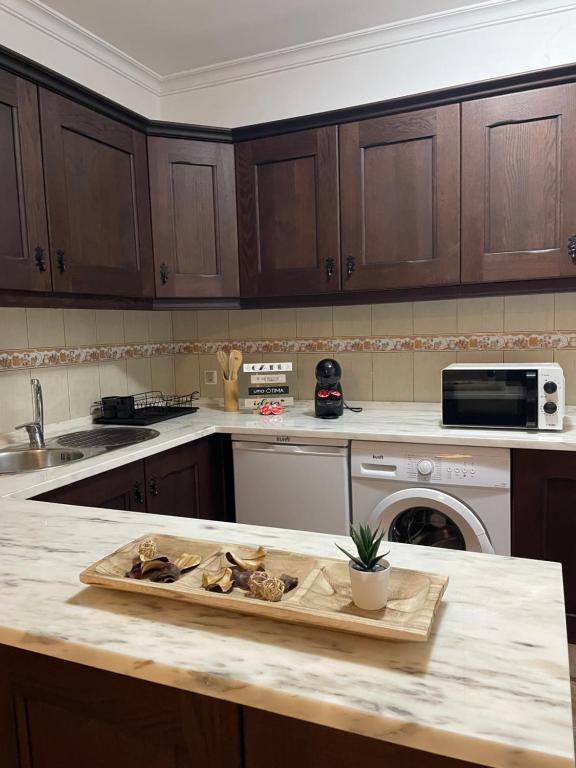 a kitchen with a wooden cutting board on a counter at A Casa da Cilarca in Portel