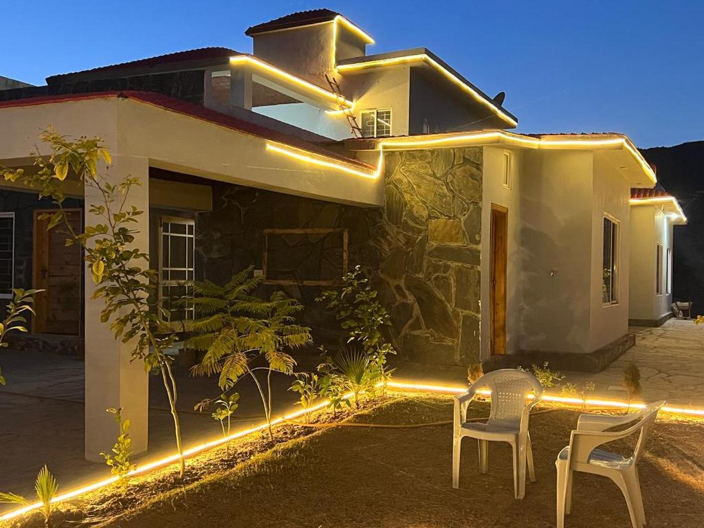 a house with lights on the side of it at Green Hills Villa in Islamabad