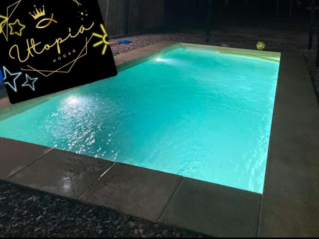 a swimming pool with blue water in the middle at Utopía in Balneario Argentino