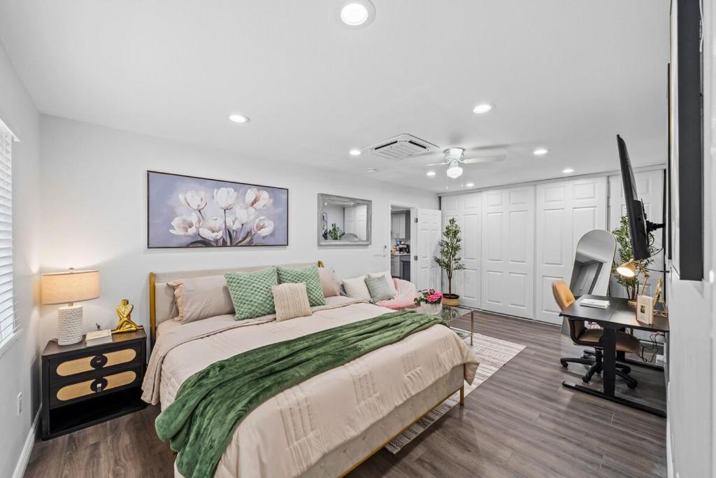 a bedroom with a bed and a desk with a computer at Entire Private 3-Bed 3-Bath House w Yard, King Bed, Prime Location in San Diego