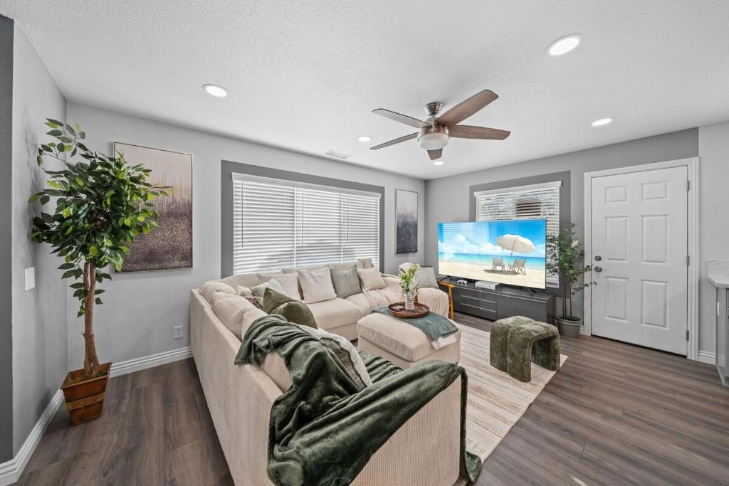 a living room with a couch and a flat screen tv at Entire Private 4BR-3Bth, King Bed, Gated Yard, Parking, Ranch, Available Now in San Diego