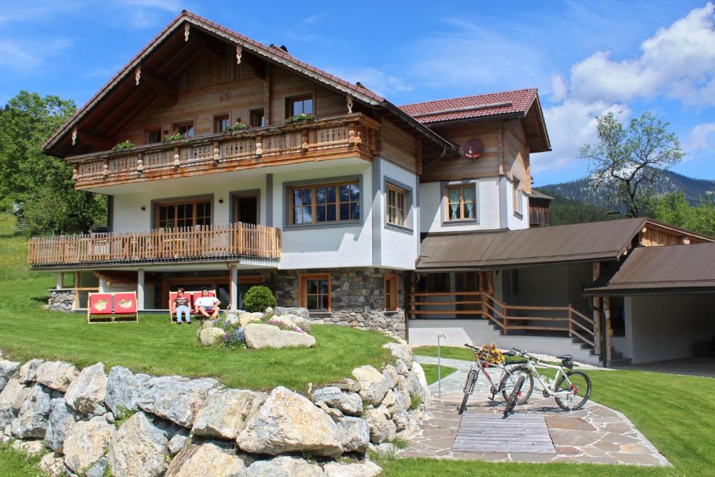 a house with two bikes parked in front of it at Alpenchalet Gosau in Gosau