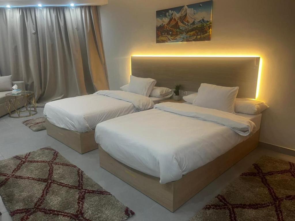 two beds in a hotel room with at Scandic resort chalet sea view in Hurghada