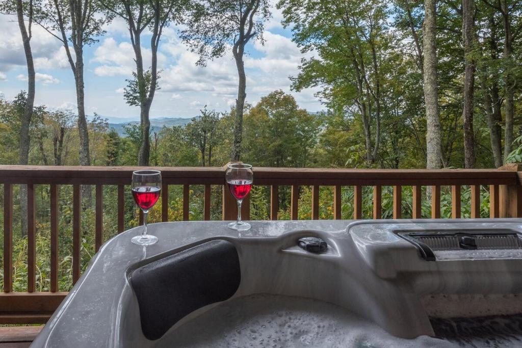 two glasses of wine sitting on top of a bath tub at Come Enjoy the Mountain Sunsets, Near Asheville in Mars Hill