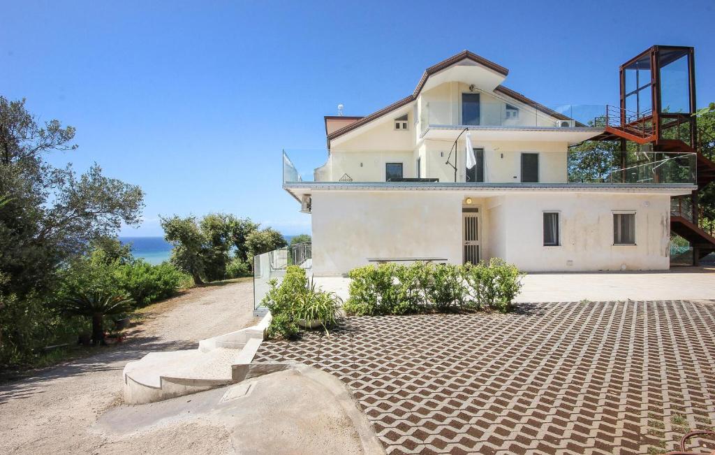 a large white house on a dirt road at Lovely Apartment In Agropoli With Wifi in Agropoli