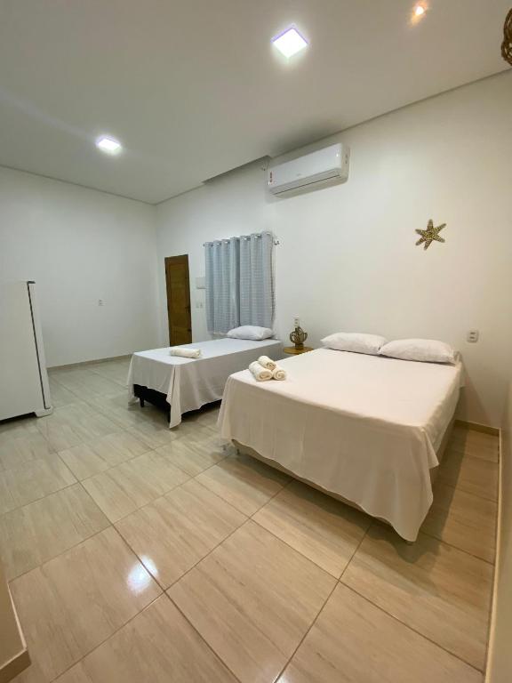 a bedroom with two beds in a room at Vila da Andrea 02 in Barreirinhas
