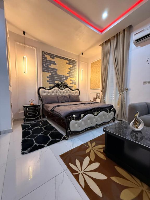 a bedroom with a king sized bed and a couch at Beautifully furnished 4 Bedroom Duplex in Lekki