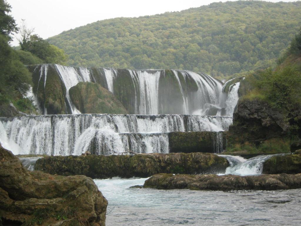 a waterfall in the middle of a river at Rooms-Vasva and Hazim in Ćukovi