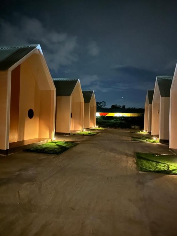 a row of houses lit up at night at Fandee suites in Ban Sa Kut