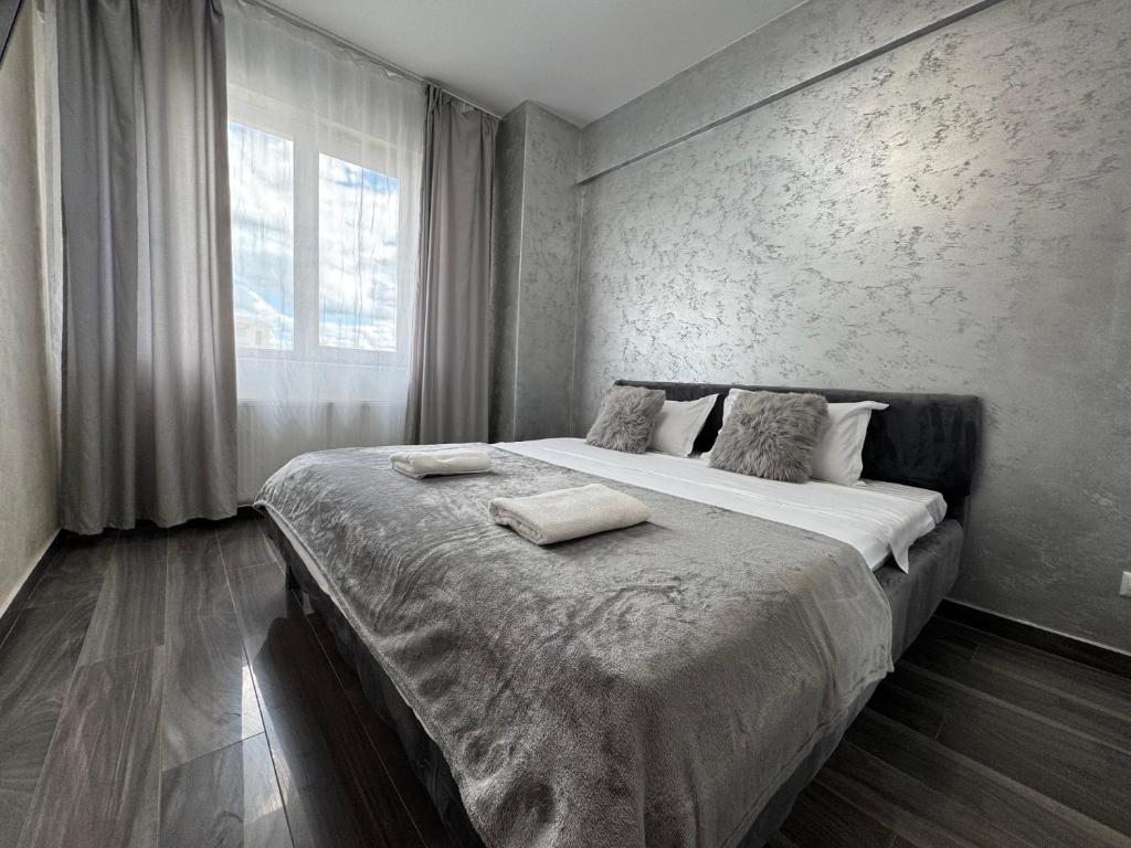 a bedroom with a large bed with two pillows on it at Spacious 2 Bedroom Apartment in Iaşi