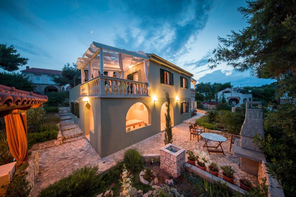 a large house with a balcony and a patio at Apartments Perla in Rukavac