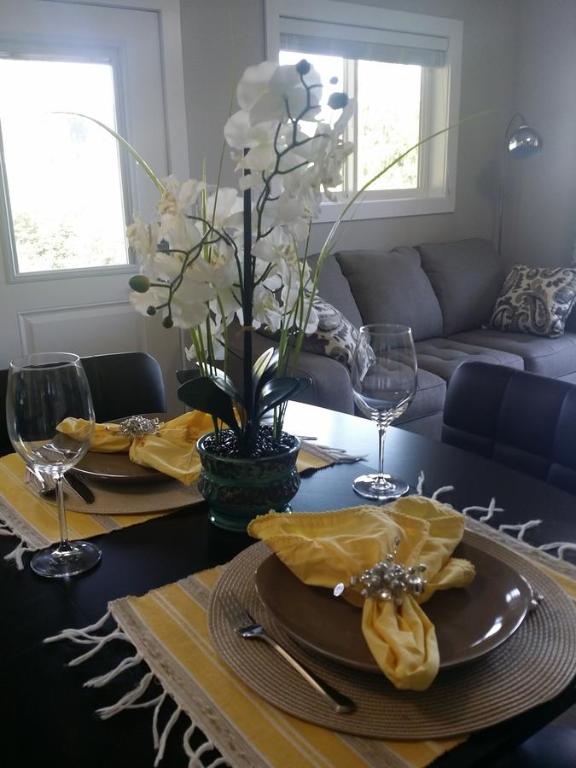 a dining room table with two plates of food on it at Cowichan Calling in Lake Cowichan