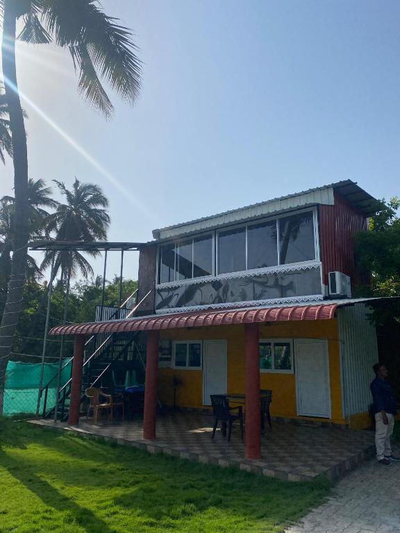 a house with a building with a playground in front of it at River view villa in Pondicherry