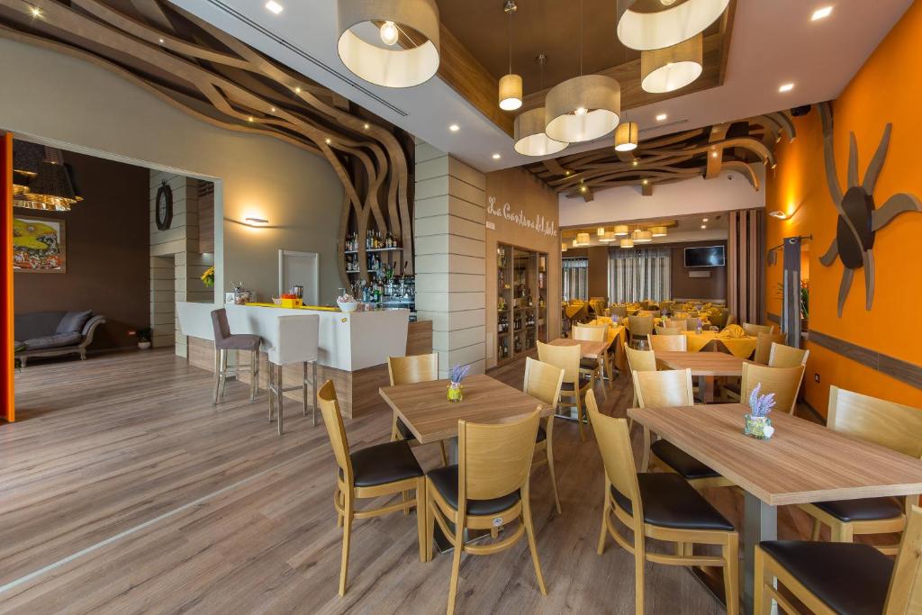 a restaurant with wooden tables and chairs and a bar at Hotel Sole in Maiori