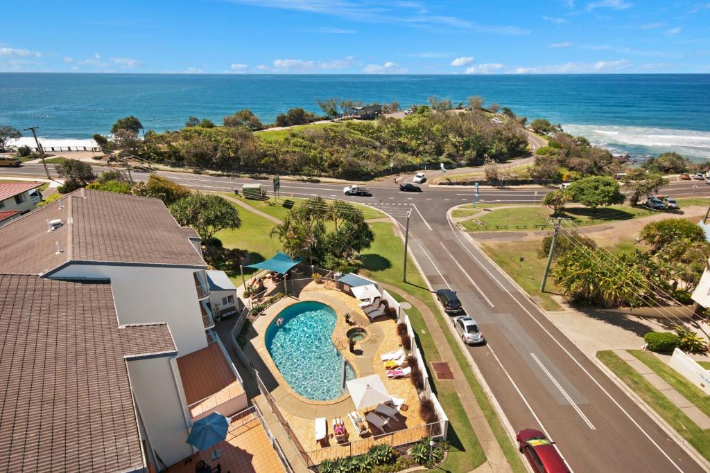an aerial view of a resort with a swimming pool and the ocean at Pandanus Coolum Beach in Coolum Beach