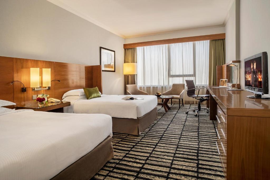 Postel nebo postele na pokoji v ubytování Jumeira Rotana – Dubai