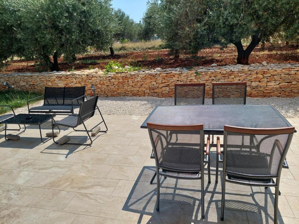 a wooden table and chairs with a table and chairs at Apartman Rebecca in Peroj
