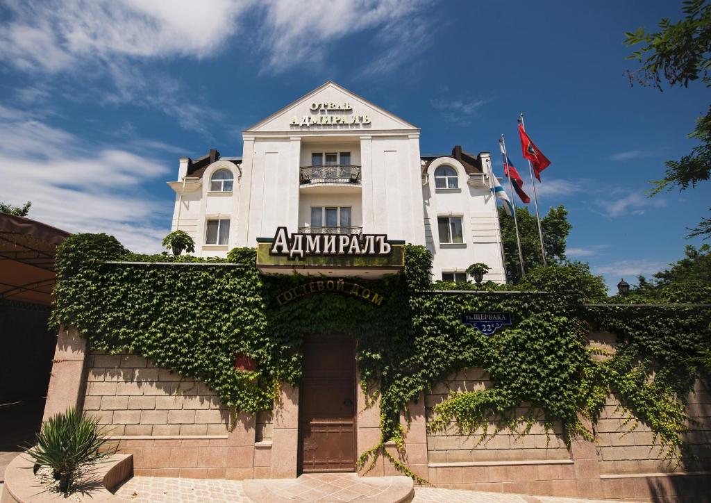 a white building with ivy growing around it at Admiral Hotel in Sevastopol