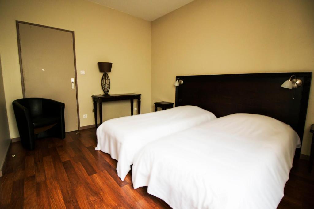 Postel nebo postele na pokoji v ubytování Ambiance Hotel