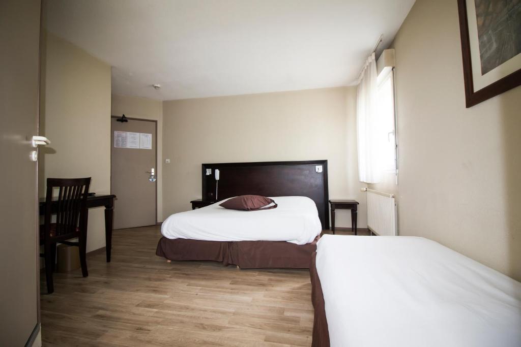 Postel nebo postele na pokoji v ubytování Ambiance Hotel