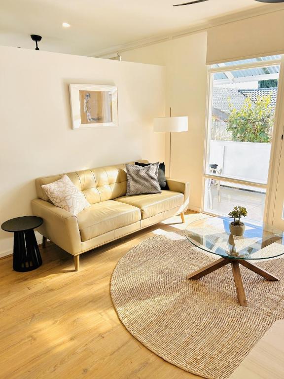 a living room with a couch and a glass table at Stunning Modern Self-contained Apartment in Beaumont