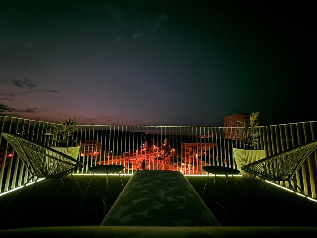 a view of a city at night with lights at designAparts - I - Penthouse mit Dachterrasse in Bayreuth