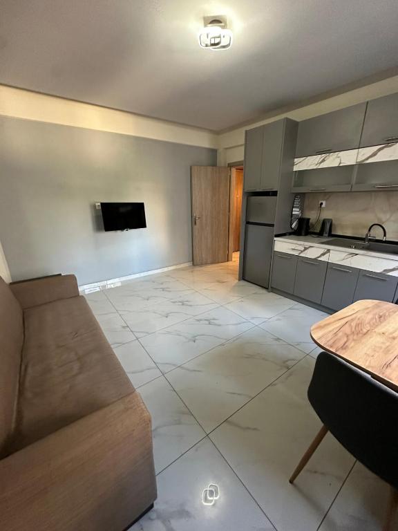 a living room with a couch and a table at Marias Apartment in Alexandroupoli