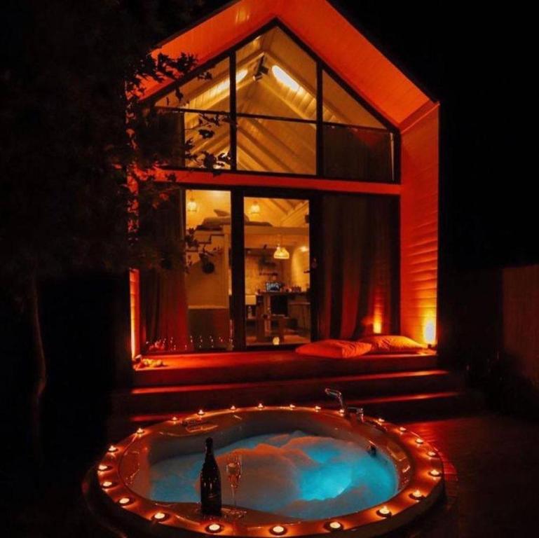 a jacuzzi tub with lights in front of a house at Boheme Bungalow Sapanca in Sapanca