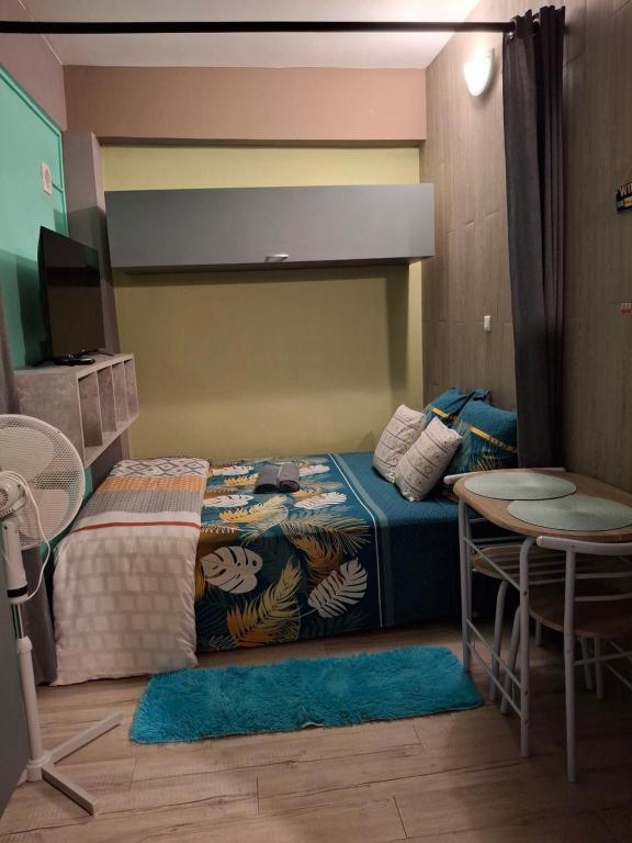 Ένα ή περισσότερα κρεβάτια σε δωμάτιο στο Le Bivouac du Maido studio 1