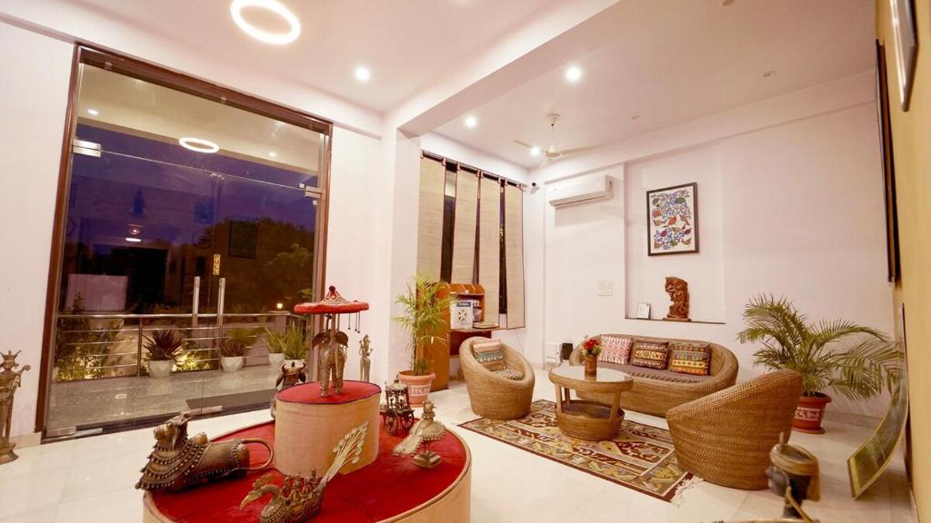 a living room filled with furniture and a large window at KURJA by Modern Haven in Jāmb