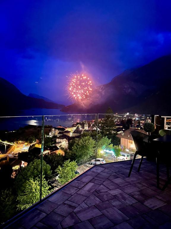 a firework in the sky over a city at night at Hotel Aurora in Molveno