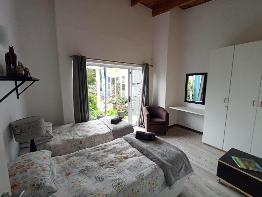 a bedroom with two beds and a window at Waterfront Stay Holiday Home in Swakopmund
