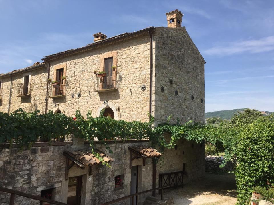 an old stone building with ivy on it at Pallano in Bomba