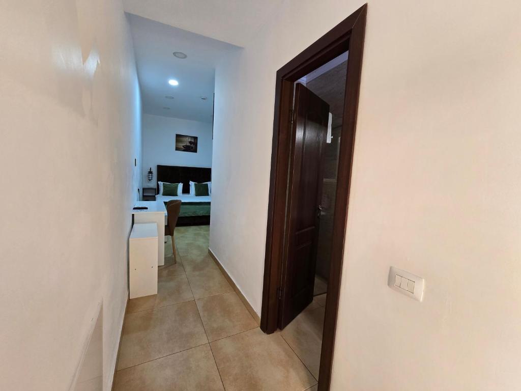 a hallway with a door leading to a living room at Poet Palace Bucharest in Bucharest