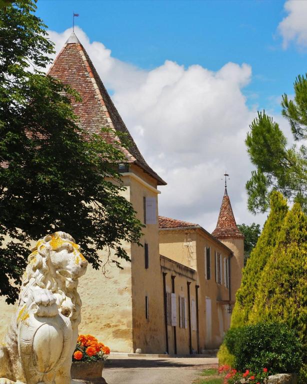 a statue of a dog in front of a building at Domaine du Château Larroque in Sainte-Christie
