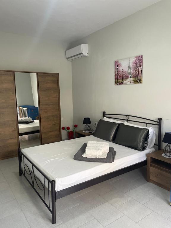 a bedroom with a large bed with a mirror at Nemesis in Litochoro