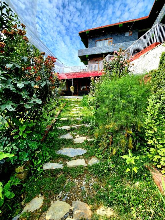 a stone path leading to a house with a building at Sneh by Daisey in Cheog