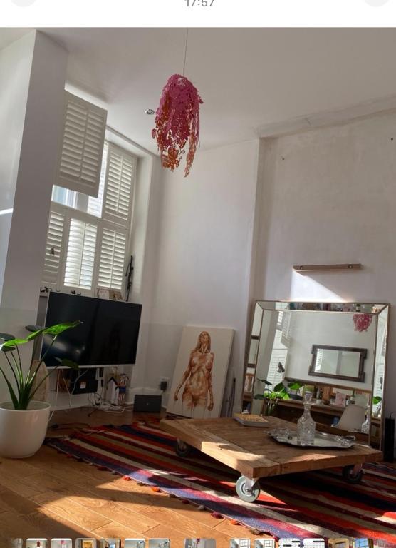a living room with a mirror and a table at 600sf 1 bedroom apartment in Moffat